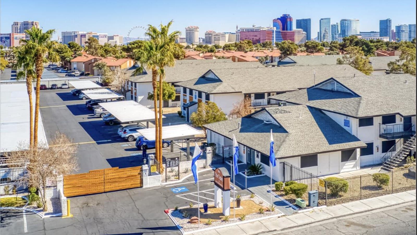 Tides at Spring Mountain — aerial of the garden-style apartment community with the Las Vegas skyline behind